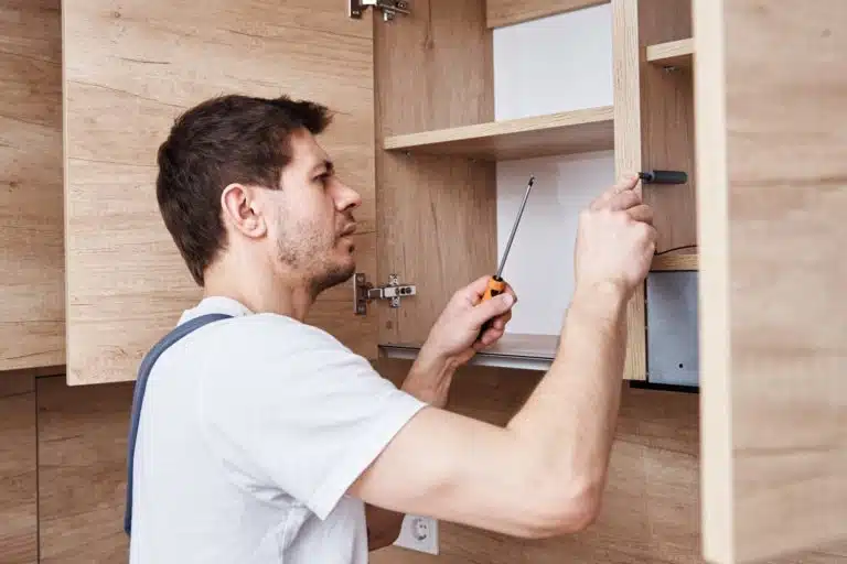 Man assembling kitchen cabinet