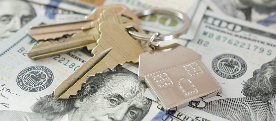 Housing Market concept - house keys on money currency, real estate, home loan, equity buy sell